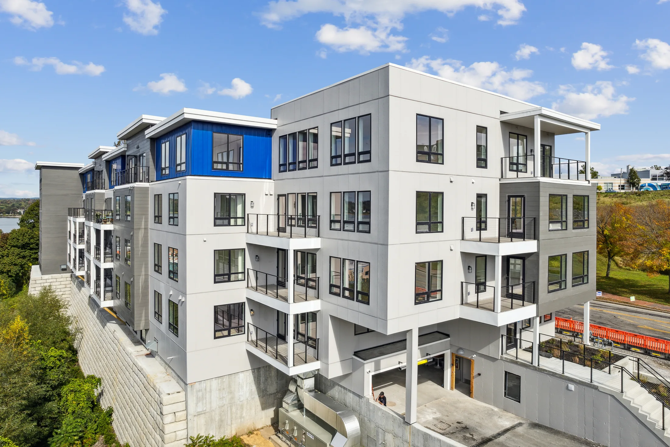 Architectural view of the balconies and blue-accented facade at 218 Washington Avenue